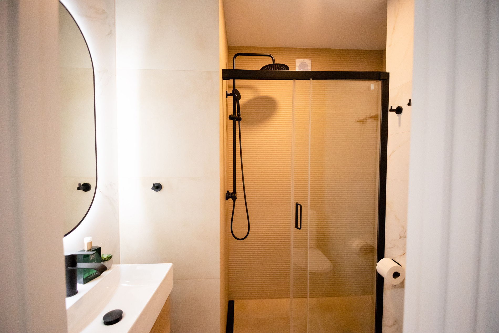 Glass shower with reeded glass and black fittings