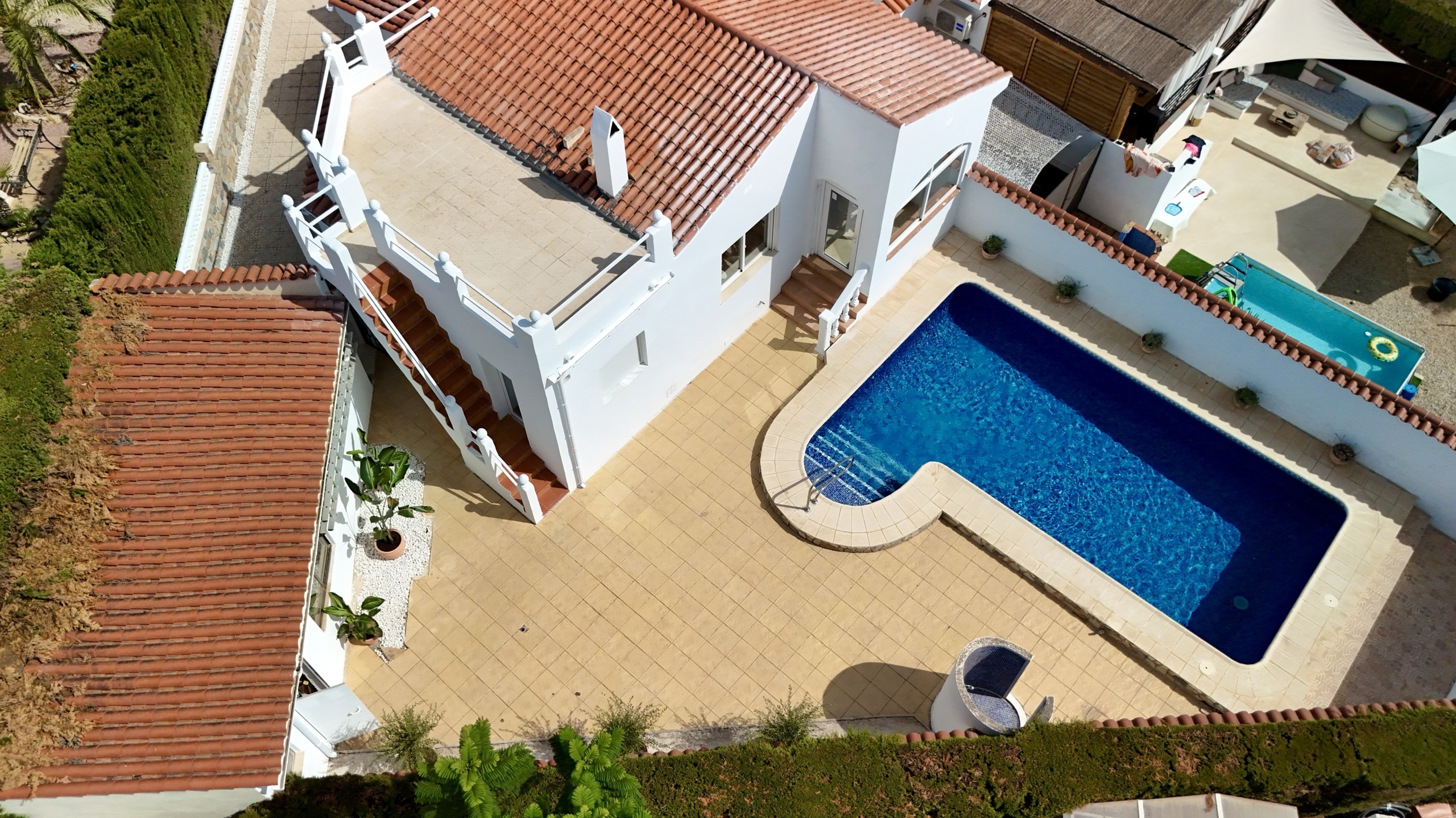 Aerial view of the white house, roof terrace, and private pool